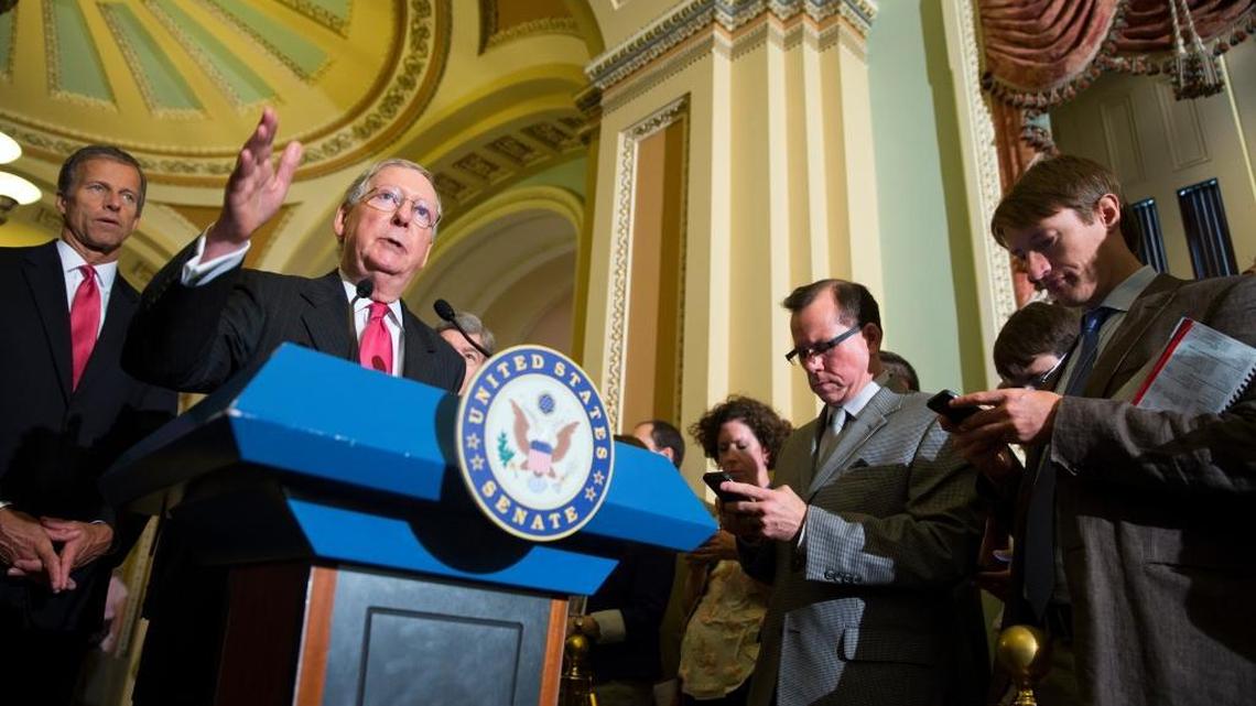 
Senate Majority Leader Sen. Mitch McConnell of Kentucky, accompanied by Sen. John Thune, R-S.D., discusses a possible government shutdown Wednesday on Capitol Hill. 
