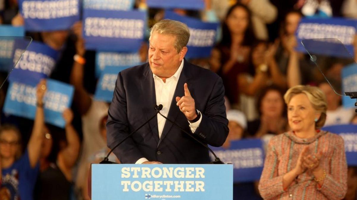 Former Vice President Al Gore speaks on climate change as Hillary Clinton listens at a campaign rally in Miami on Tuesday.