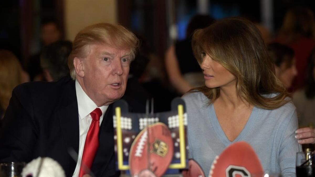 President Donald Trump and first lady Melania Trump watch the Super Bowl at Trump International Golf Club in West Palm Beach, Fla., on Sunday.