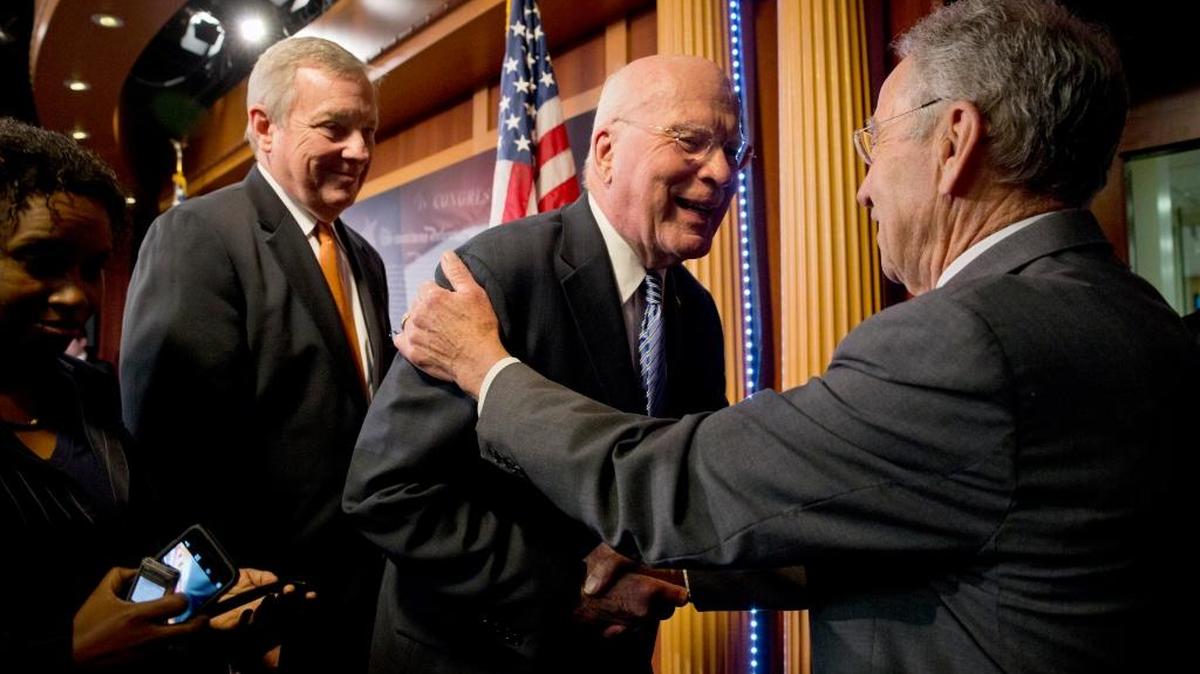 
Sens. Charles Grassley, R-Iowa, right, and Patrick Leahy, D-Vt., shake hands Thursday at a news conference to announce a bill on federal sentencing reform.
