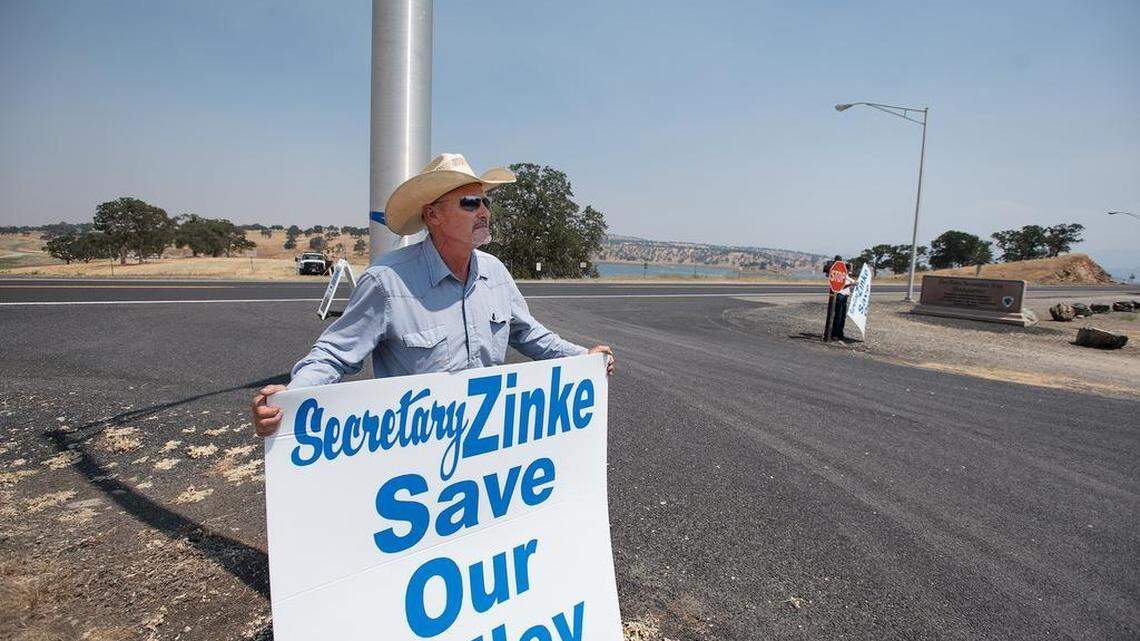 Rancher and farmer Todd Sill of La Grange stands outside the Don Pedro Recreation area with a message for visiting Interior Secretary Ryan Zinke on July 20.