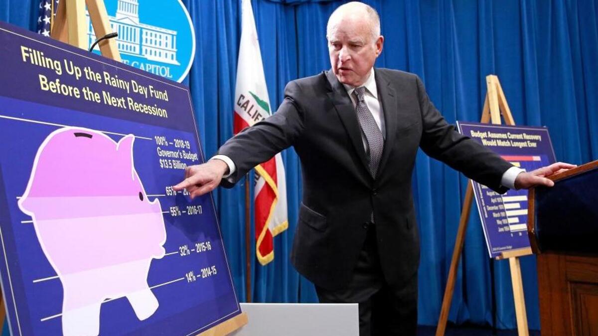 Gov. Jerry Brown points to a chart showing the growth of the state’s rainy day fund as as he discusses his proposed 2018-19 state budget in January. On Friday, he and legislative leaders agreed to a $200 billion spending plan that the Legislature will vote on this week.
