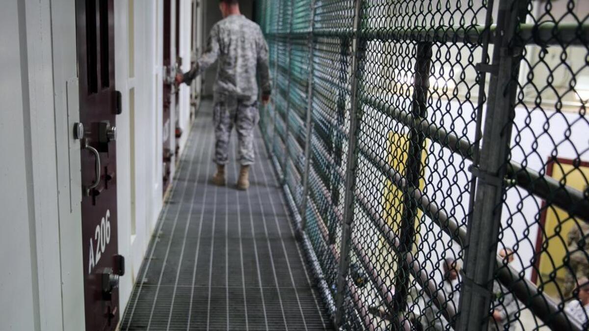 An Army captain walks outside unoccupied cells earlier this month inside Camp 6 at the detention center at Guantánamo Bay, Cuba.
