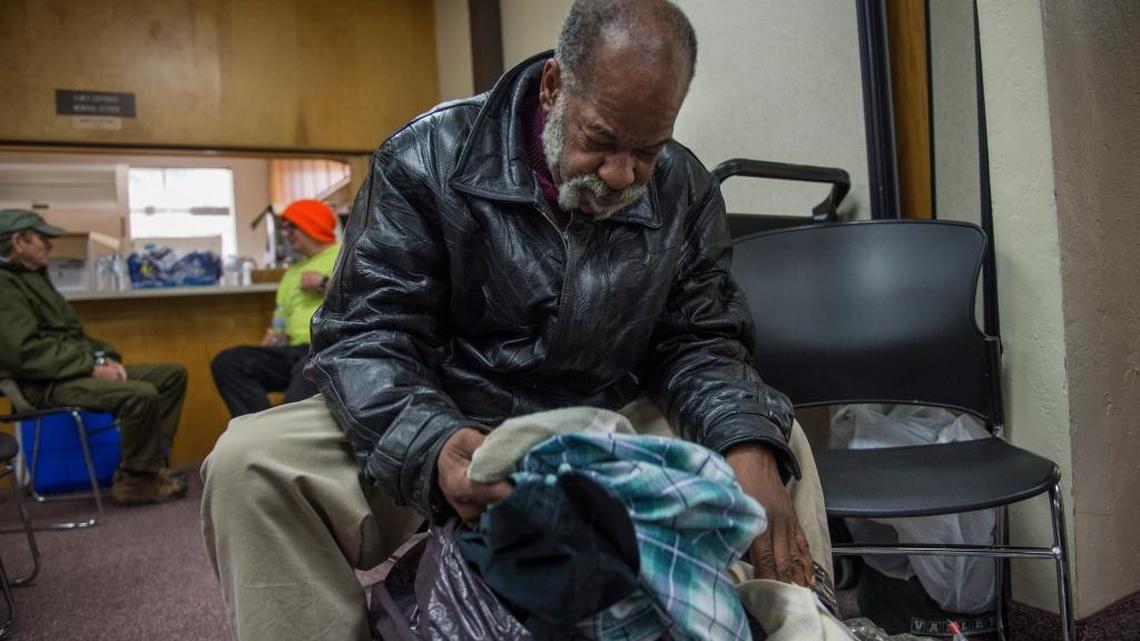 Raymond Neal, a homeless veteran, goes through a bag of items he received along with other services at a Homeless Care Fair event last month at midtown’s First Church of the Nazarene.