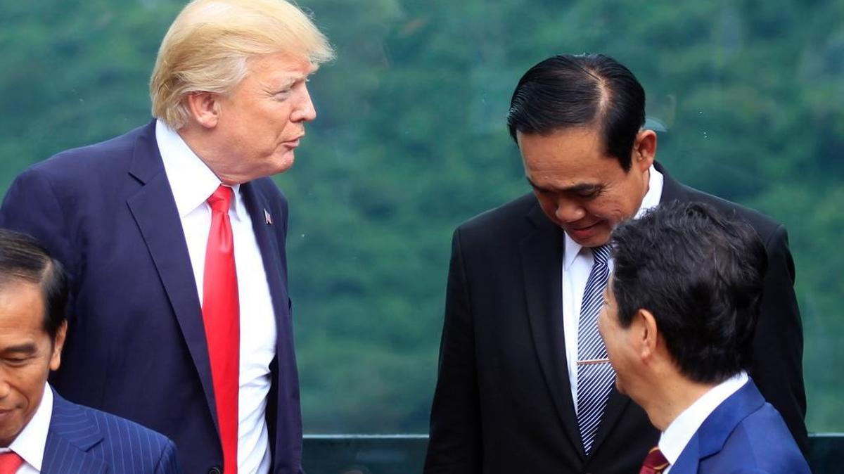 President Donald Trump, left, talks with Thai Prime Minister Prayuth Chan-ocha during the Asia-Pacific Economic Cooperation summit in Danang, Vietnam on Nov. 11.