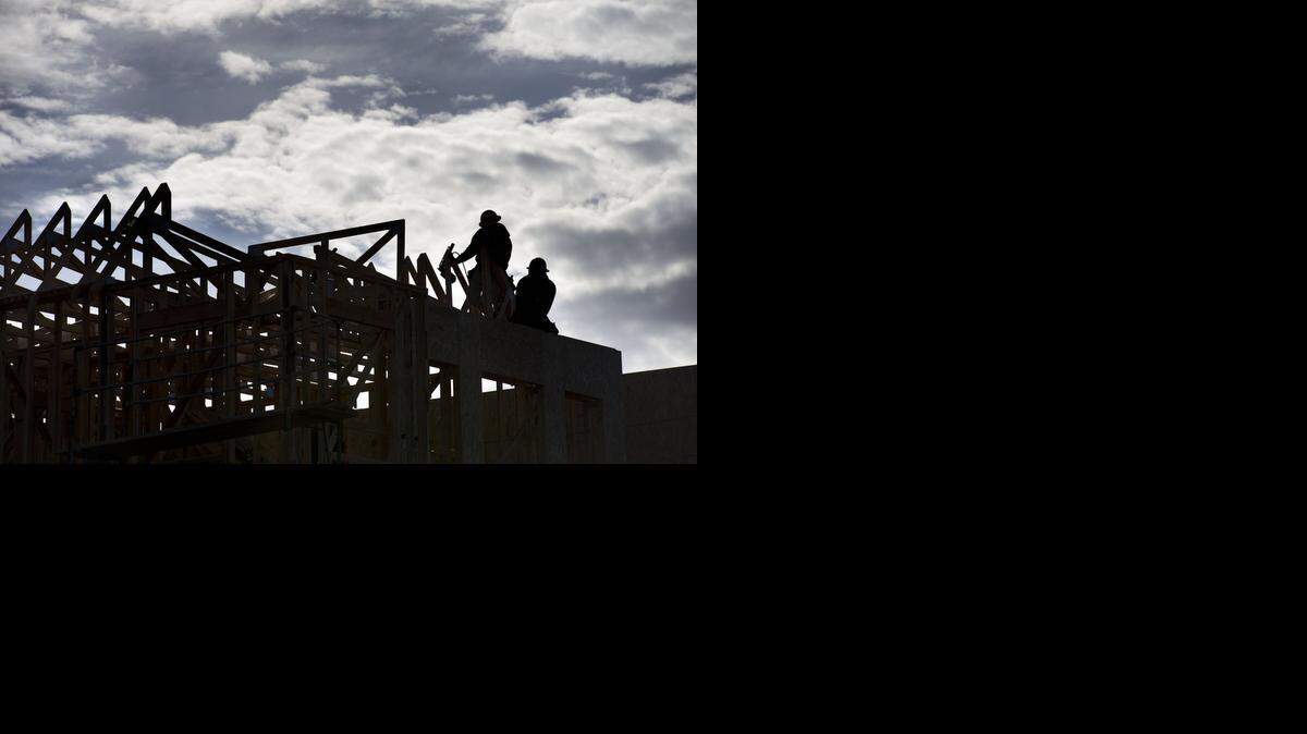 
Carpenters work on a home in Curtis Park Village. Residents say a proposed gas station is inconsistent with approved development guidelines.

