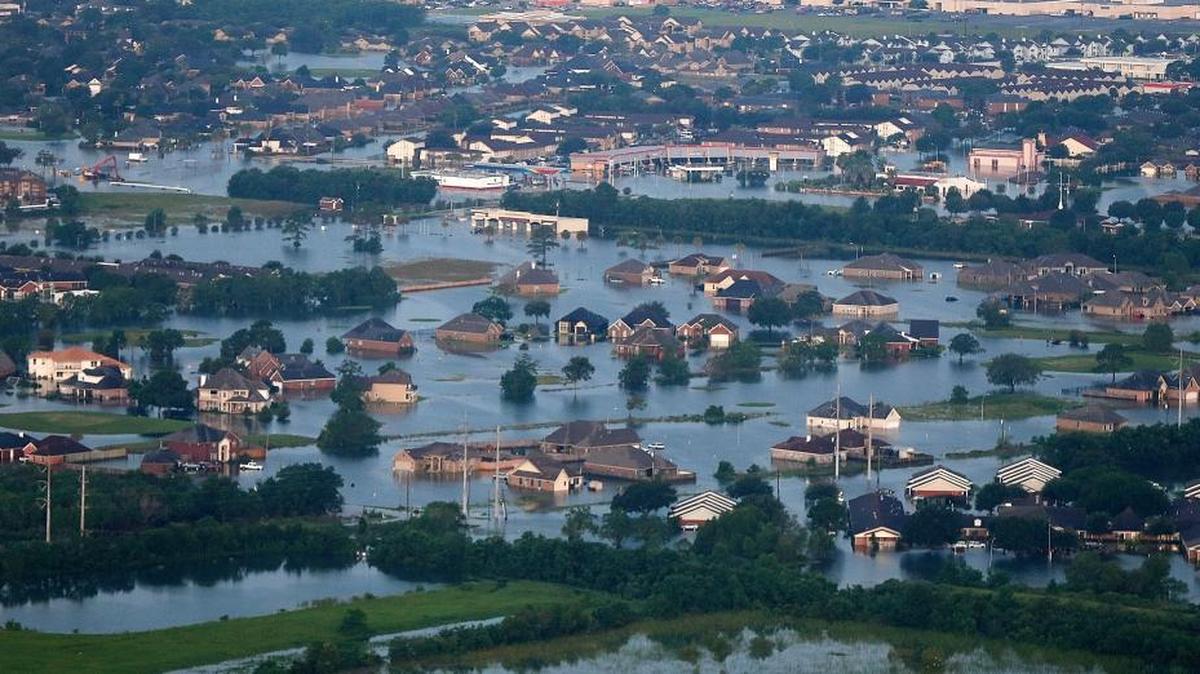 Floodwaters from Tropical Storm Harvey surround homes and businesses in Port Arthur, Texas, Aug. 31, 2017. (AP Photo/Gerald Herbert)