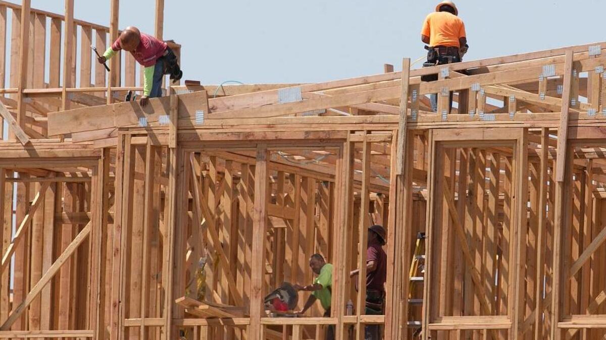 Builders work on an apartment complex in Sacramento. The Legislature could vote as soon as Friday on bills that would address California’s housing crisis.