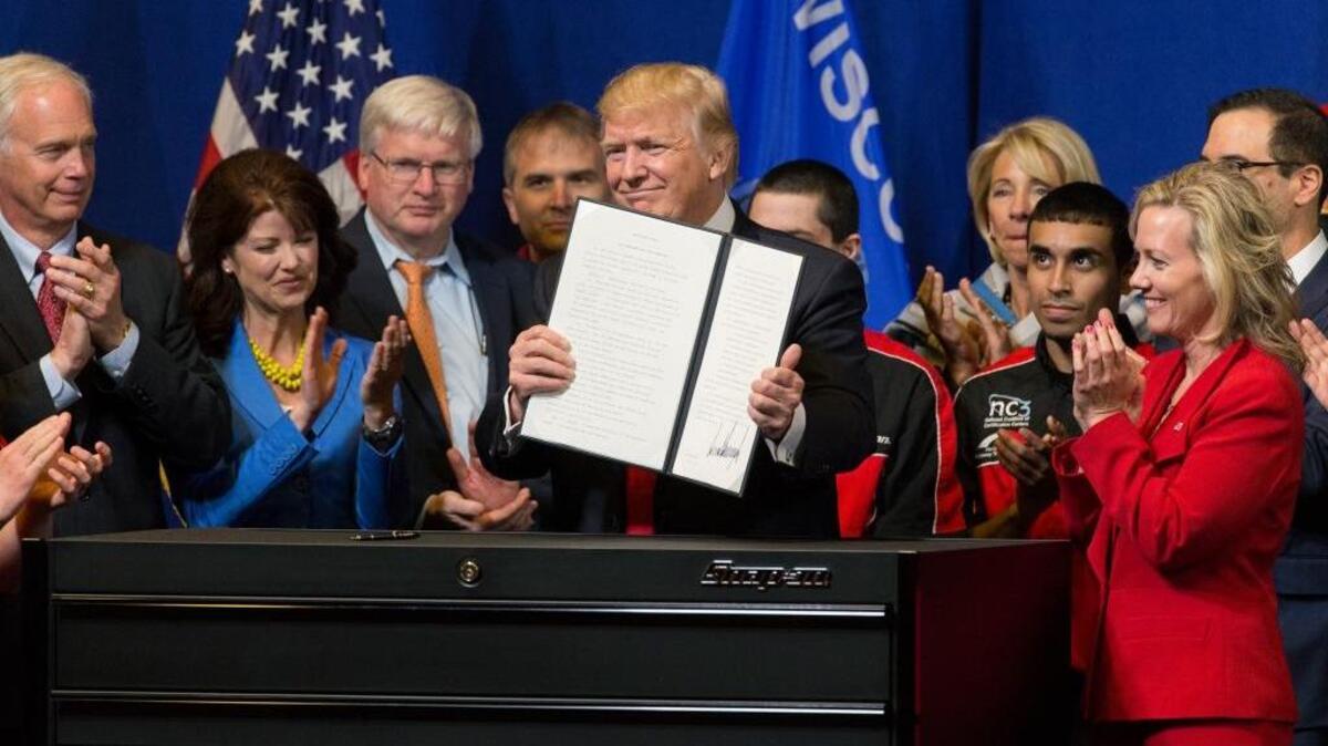 President Donald Trump signs the so-called “Buy American, Hire American” executive order on Tuesday during a visit to Snap-on Inc. in Kenosha, Wis. The order clamps down on guest-worker visas and require federal agencies to buy more goods and services from U.S. companies and workers.
