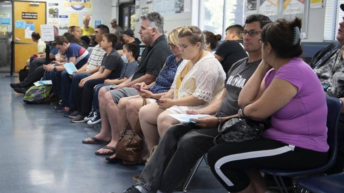 Customers wait for their number to be called at a Department of Motor Vehicles office in Sacramento on June 14.