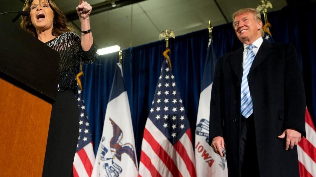 Former Alaska Gov. Sarah Palin, left, endorses Republican presidential candidate Donald Trump during a rally at the Iowa State University on Tuesday.