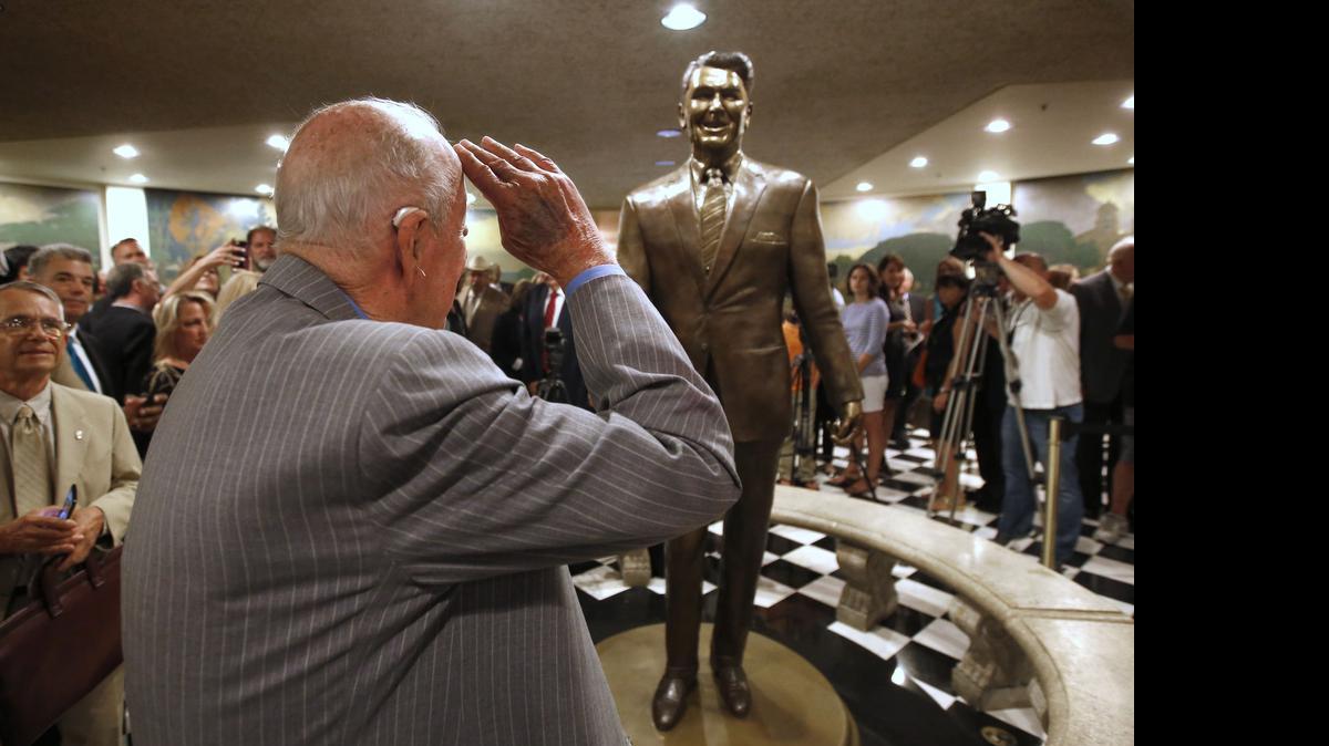 
Former Secretary of State George Shultz salutes a statue of his former boss, President Ronald Reagan, that was unveiled at the state Capitol on Monday.
