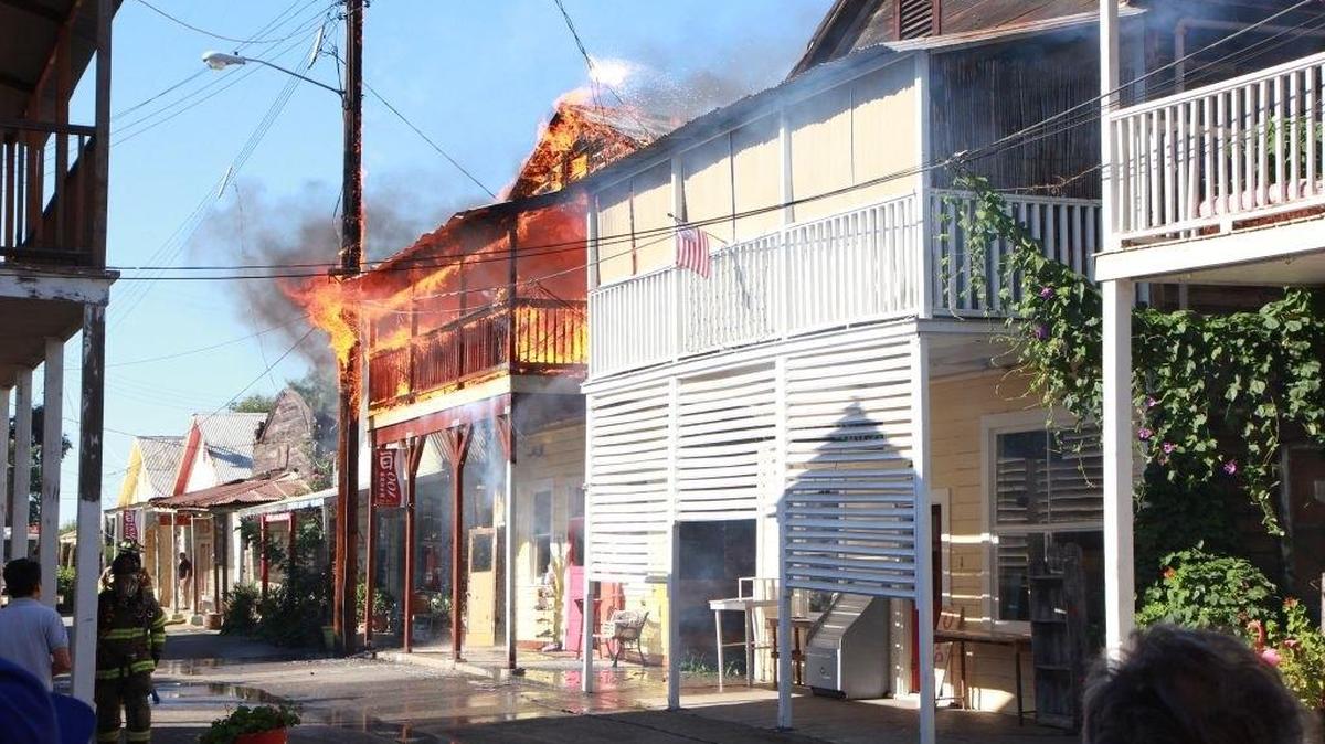 An apartment above a knickknack shop in historic Locke burns on Sunday. Firefighters kept the flames from consuming the wooden town.
