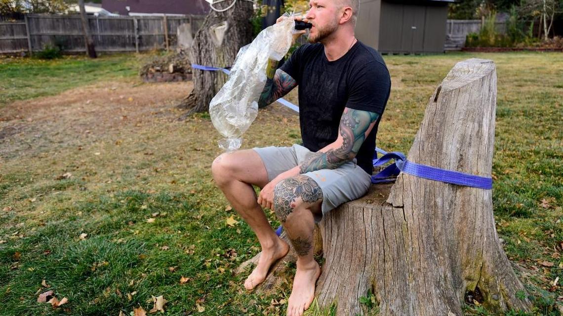 Veteran Curt Bean smokes marijuana for relief from PTSD in his backyard in Lakewood, Colo., last November. The American Legion has joined veterans groups calling for research into the possible benefits of marijuana.