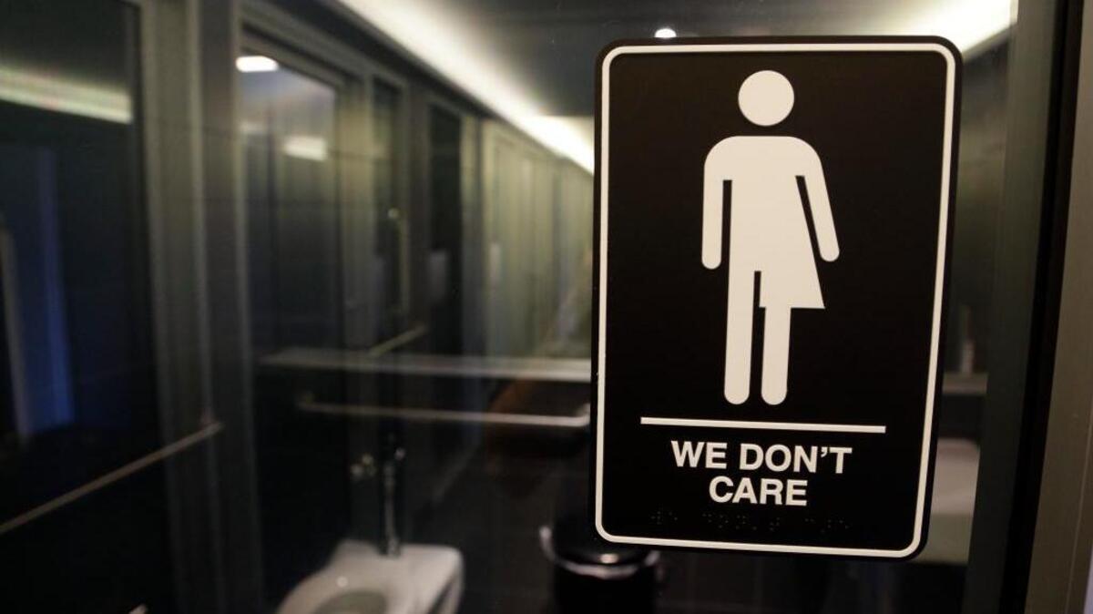 A sign outside of a restroom at the 21c Museum Hotel in Durham, N.C. North Carolina is in a legal battle with the federal government over a state law that requires transgender people to use the public restroom matching the sex on their birth certificate.