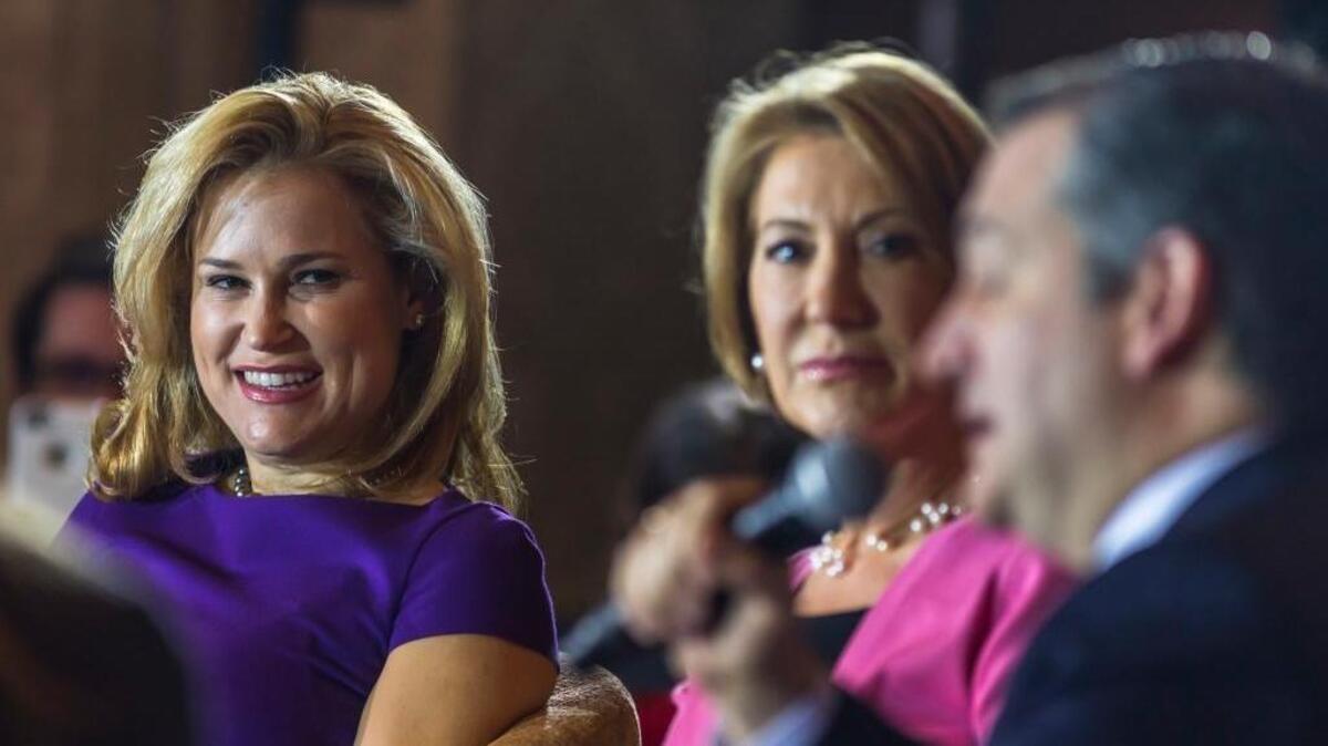 Carly Fiorina, center, and Heidi Cruz, left, listen as Sen. Ted Cruz, R-Texas, speaks in Madison, Wis., on Wednesday. Fiorina is backing Cruz, but still hasn’t taken her name off the June 7 California presidential primary ballot.