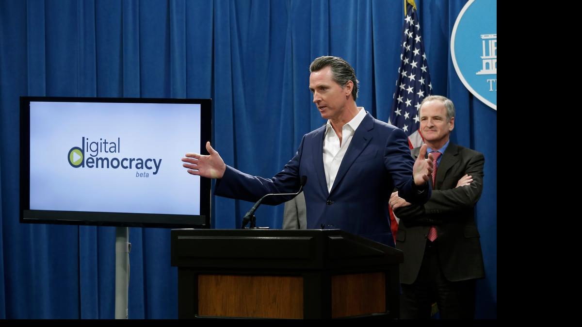 
Lt. Gov. Gavin Newsom discusses a new video search engine that allows the public to to track legislative hearings during a news conference in Sacramento. Newsom and former state Sen. Sam Blakeslee, R-San Luis Obispo, right, joined computer scientists from Cal Poly San Luis Obispo to develop Digital Democracy, which uses the latest in voice and face recognition software to see, hear and read what lawmakers are doing in the state Capitol. 
