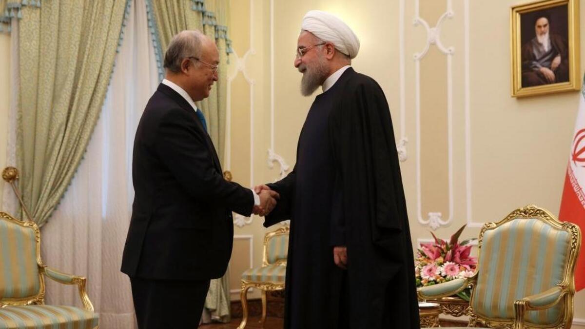 Iranian President Hassan Rouhani, right, welcomes the International Atomic Energy Agency’s director general, Yukiya Amano, for their meeting in Tehran on Monday. The IAEA certified Saturday that Iran has complied with a nuclear deal.