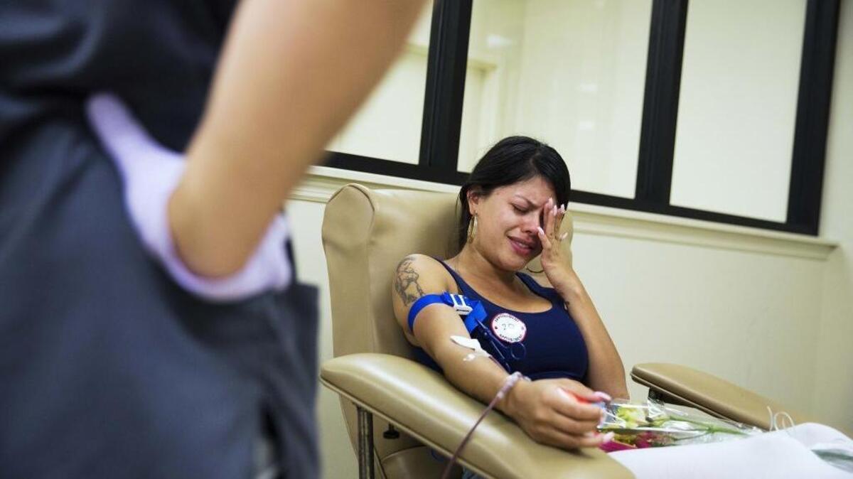 Tatiana Osorio cries while giving blood near the Orlando nightclub Pulse. Osorio lost three friends in the last weekend’s mass shooting at the gay club.