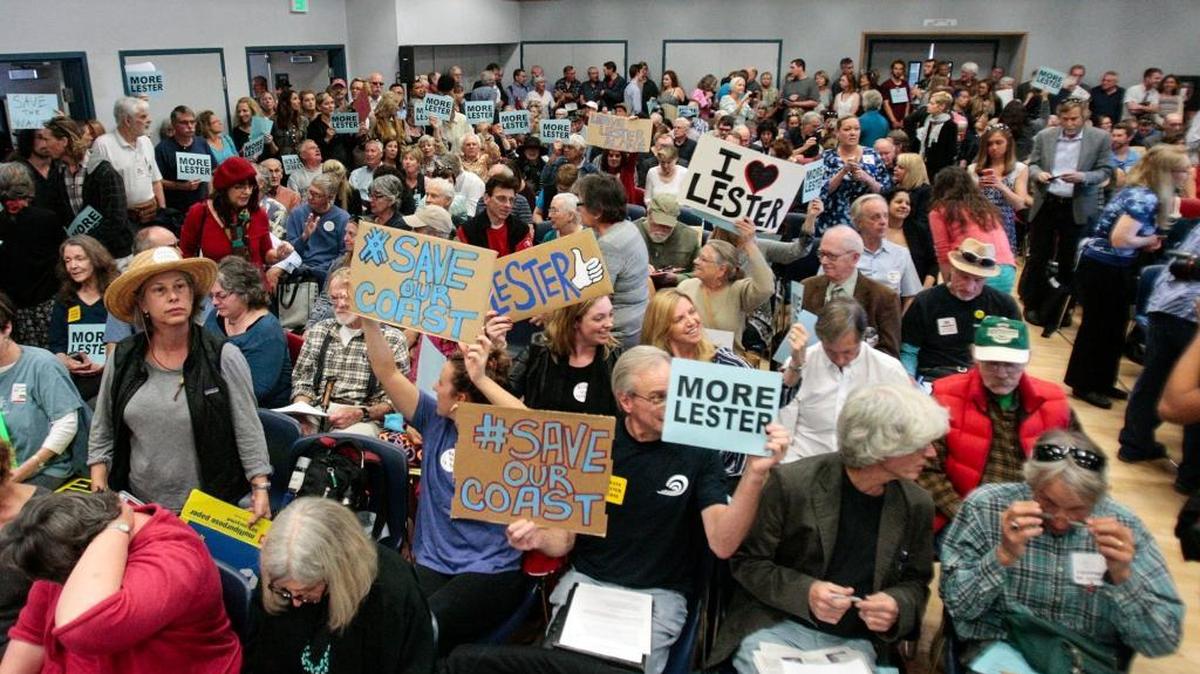 Protesters defend the outgoing executive director of the California Coastal Commission, Charles Lester, before his firing on Wednesday at a public hearing in Morro Bay.