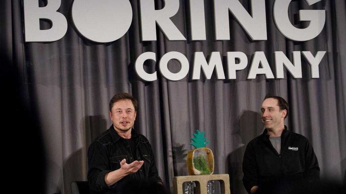 Elon Musk, left, CEO of Tesla, and Steve Davis, operations head of The Boring Company, hold an event in Los Angeles.