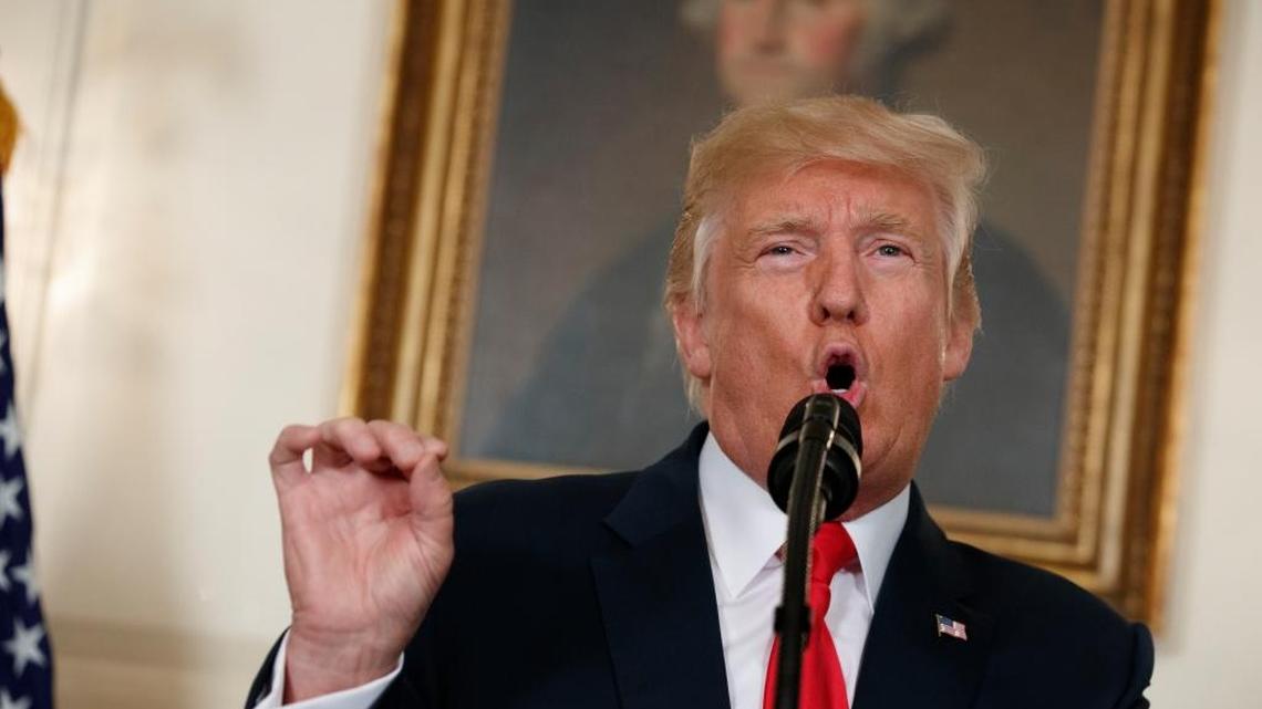 President Donald Trump speaks in front of a portrait of George Washington, in the Diplomatic Room of the White House in Washington.