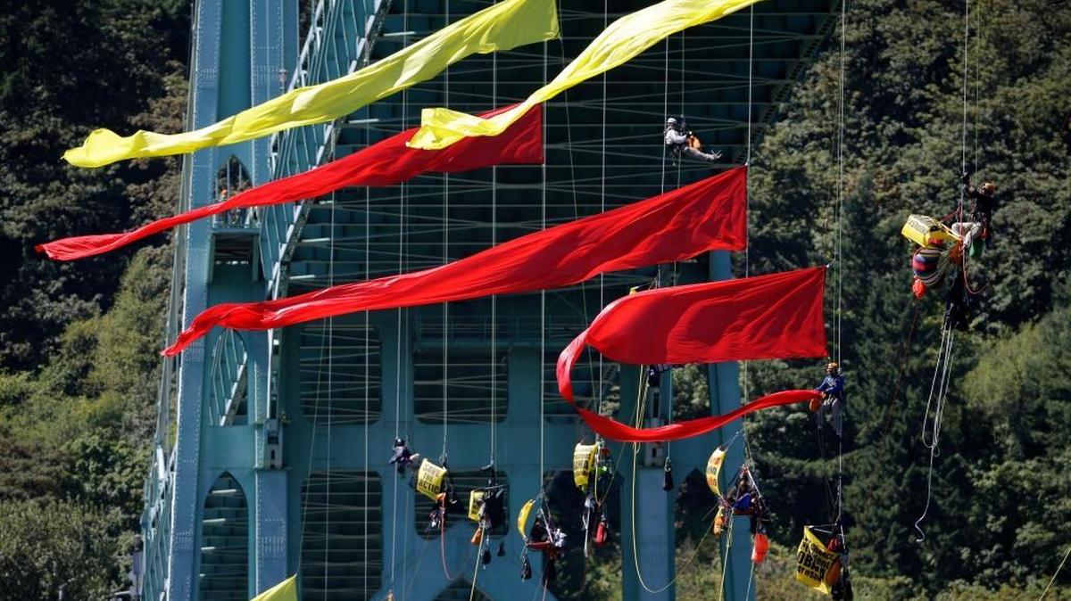 
Activists in July dangle from the St. Johns Bridge in Portland to protest the departure of a Royal Dutch Shell PLC icebreaker that was part of the company’s oil exploration in the Alaskan Arctic. The company this week announced it was retreating from Arctic projects.
