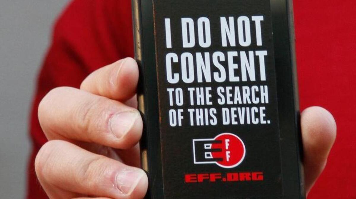 A man holds out his iPhone during a rally in support of data privacy outside the Apple store in San Francisco on Feb. 23. Apple resisted a court order requiring it to help the FBI unlock an encrypted iPhone used by a gunman in the San Bernardino mass shooting, but the FBI announced Monday that it found a way to access the phone on its own.