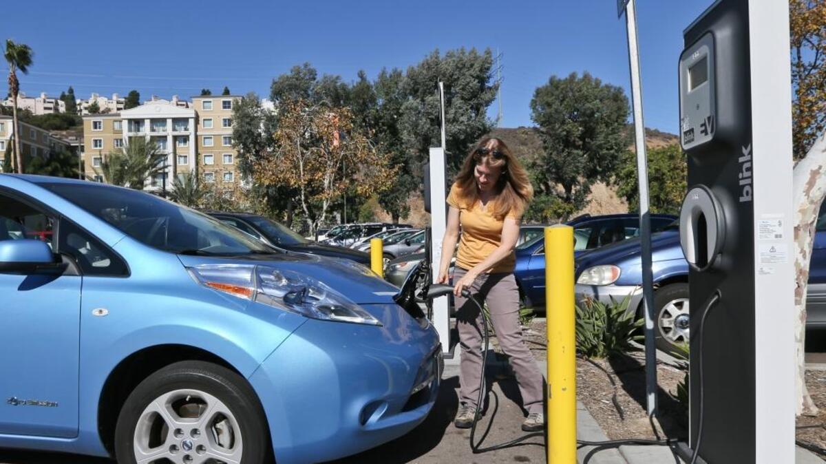 A San Diego shopper plugs in her Nissan Leaf electric vehicle at a mall in San Diego. What if refueling looked like this in the new development in Curtis Park?