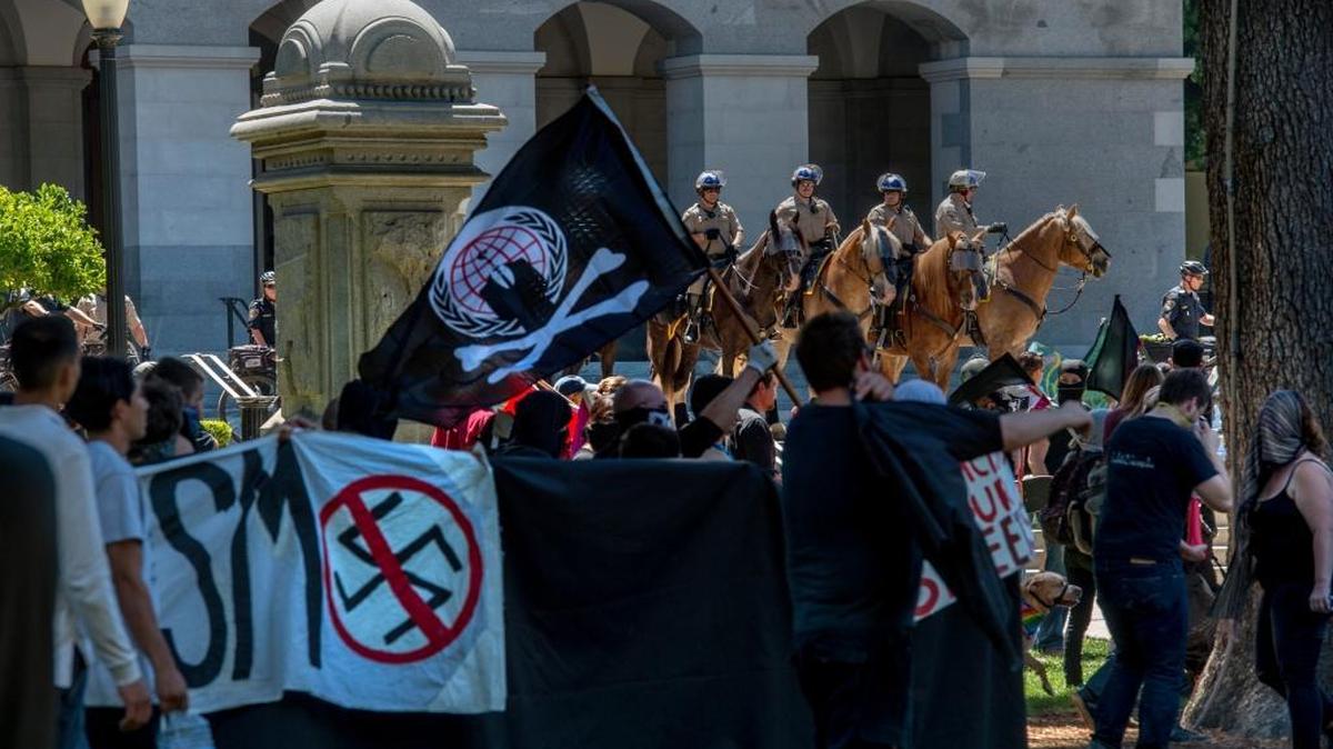 Mounted police officers stand guard Sunday at the state Capitol, where clashes between neo-Nazis and anti-fascist protesters injured at least 10.