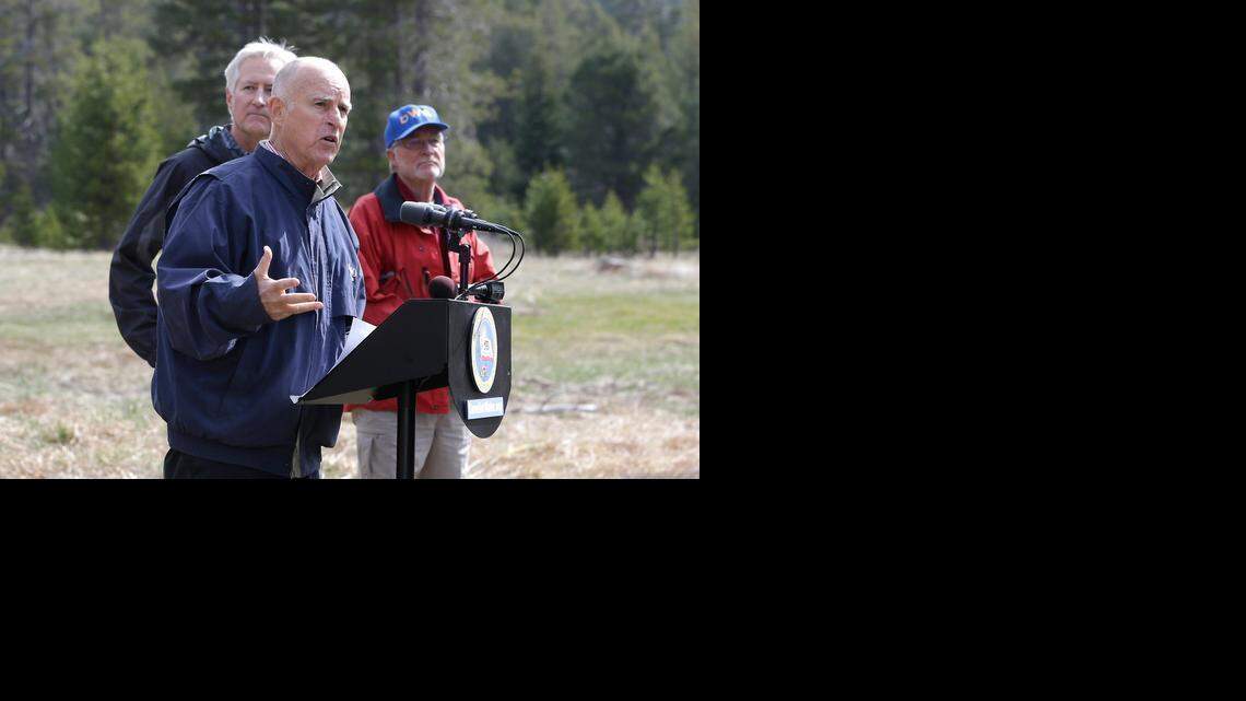 
Gov. Jerry Brown, center, announces mandatory water restrictions Wednesday with Mark Cowin, left, director of the state Department of Water Resources, and Frank Gehrke, chief of the California Cooperative Snow Surveys Program for the DWR. 
