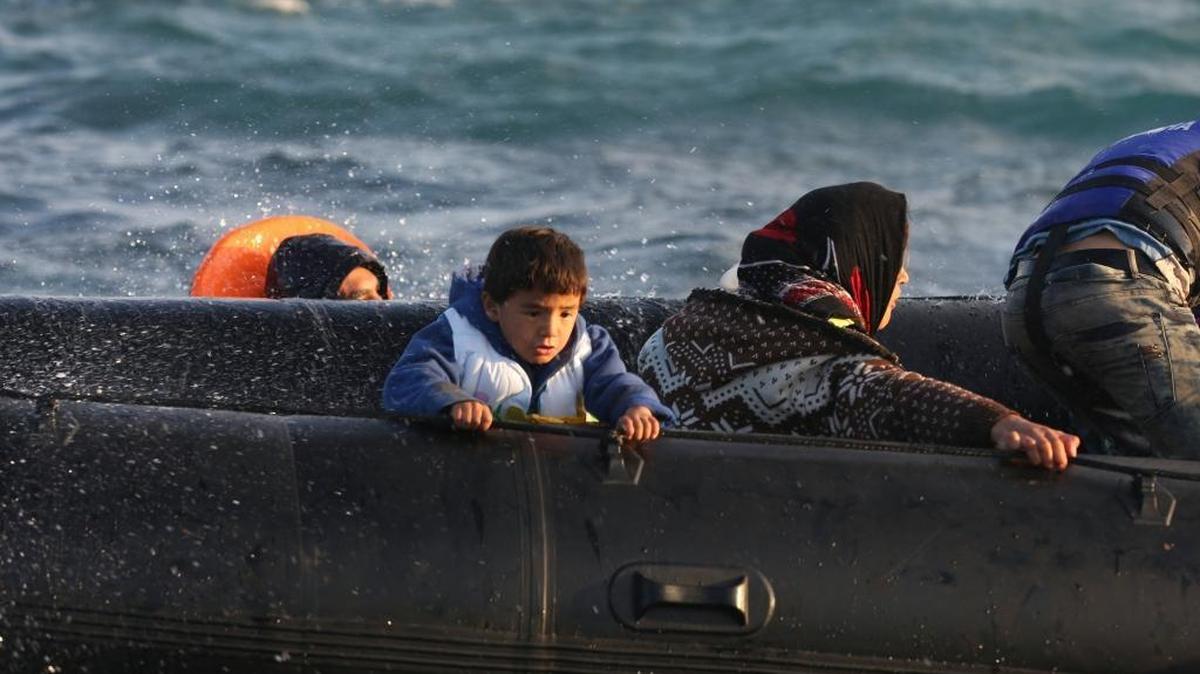 Refugees and migrants on a dinghy give up trying to get from the Turkish coast to the Greek island of Chios on Oct. 31. So far this year, nearly 800,000 migrants have survived the dangerous sea journey to Europe, but more than 3,400 have died or gone missing.