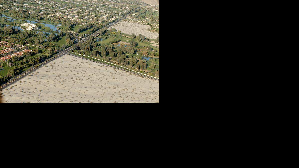 
An aerial photo last week shows golf course communities bordering the desert in Cathedral City, near Palm Springs. Unlike many water agencies in Southern California that have strong conservation programs, the ones in this area will have to slash water use by 35 percent because their per-capita use is so high. 

