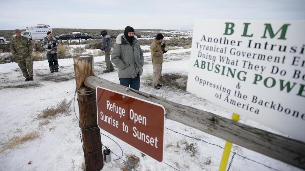 Members of the group occupying the Malheur National Wildlife Refuge stand guard on Monday. The group calls itself Citizens for Constitutional Freedom and has sent a "demand for redress" to local, state and federal officials.