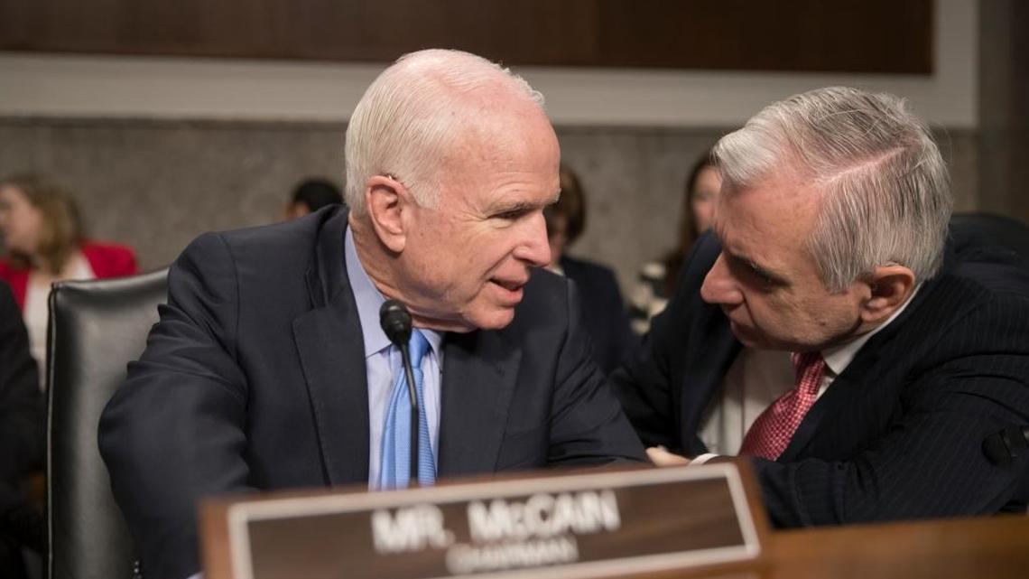 Sen. John McCain, left, confers with Sen. Jack Reed, D-R.I., during an Armed Services Committee hearing Thursday on Afghanistan.