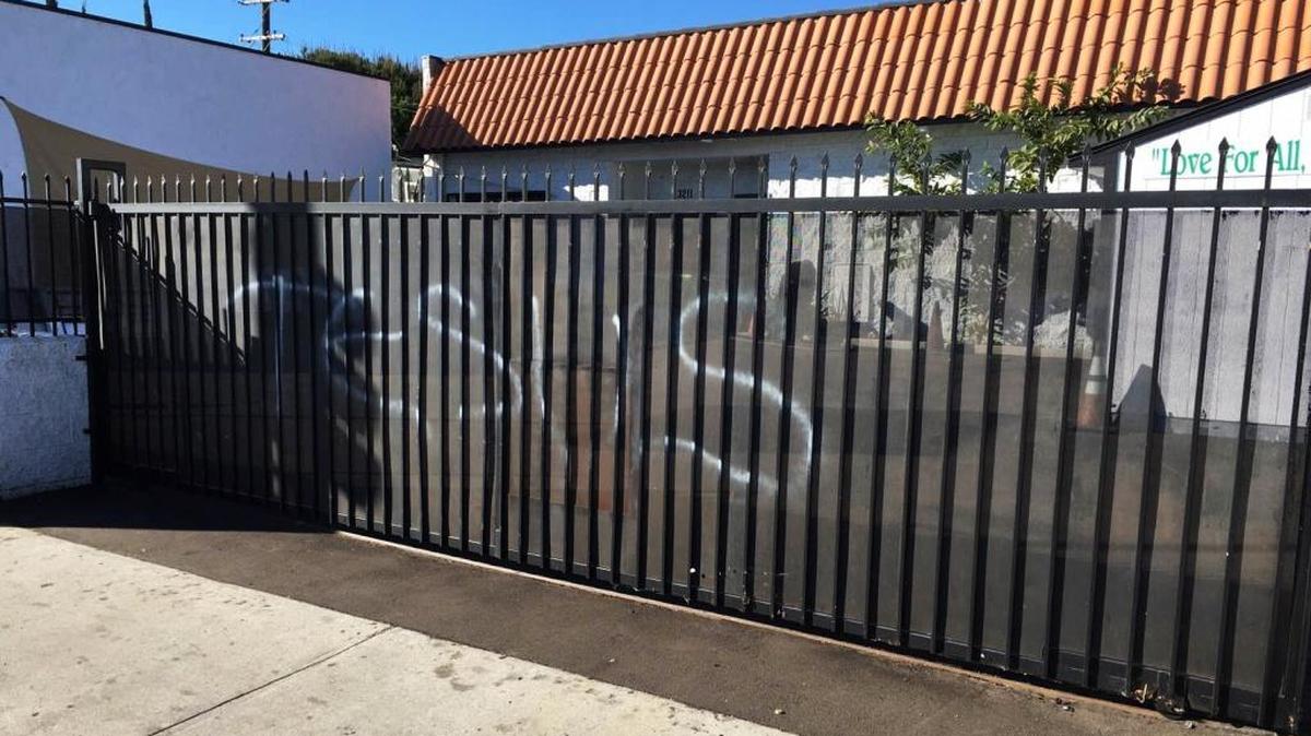Vandals wrote "Jesus" in spray paint on a gate at the Ahmadiyya Muslim Community Baitus-Salaam Mosque in Hawthorne on Sunday. The FBI is investigating after police in Hawthorne say two mosques in that city were vandalized with paint, and a fake grenade was left in the driveway of one of the properties.