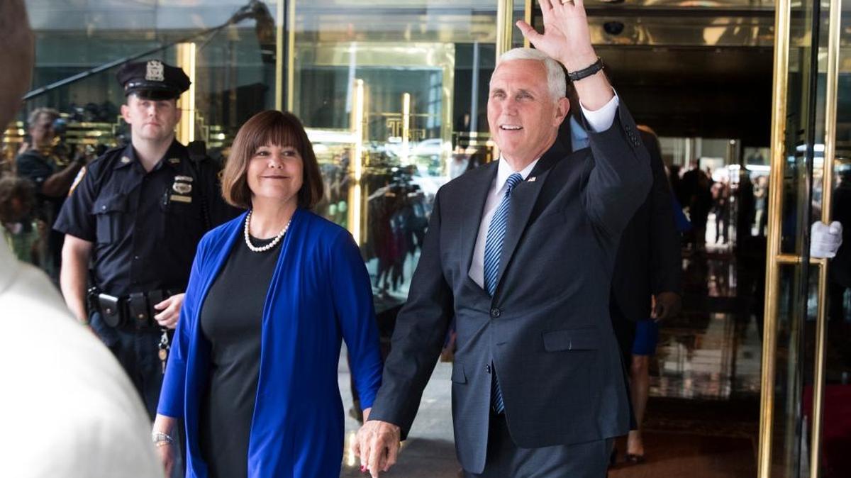 Indiana Gov. Mike Pence, accompanied by his wife Karen, waves as he leaves a meeting with presumptive presidential nominee Donald Trump in New York on Friday.