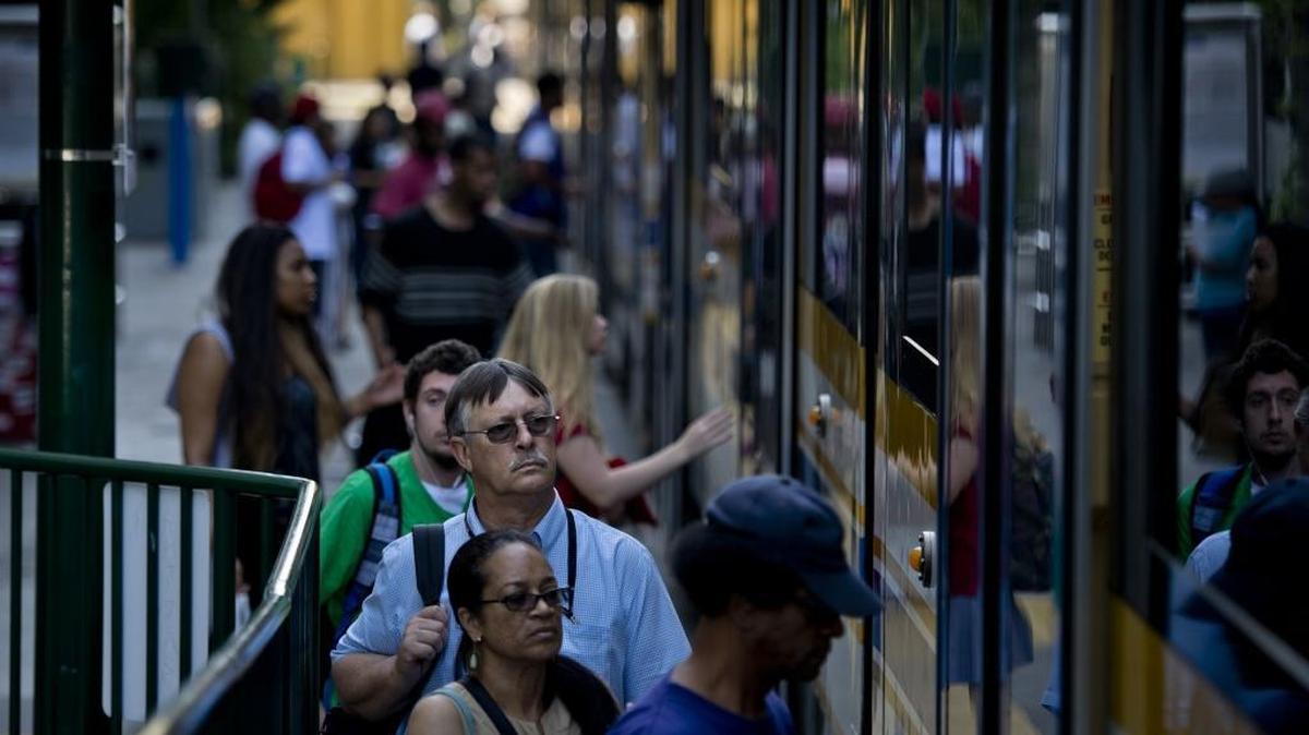 Riders board a Regional Transit light-rail train at the 16th Street station. After two deaths, RT now has a 20 mph speed limit for arriving trains.