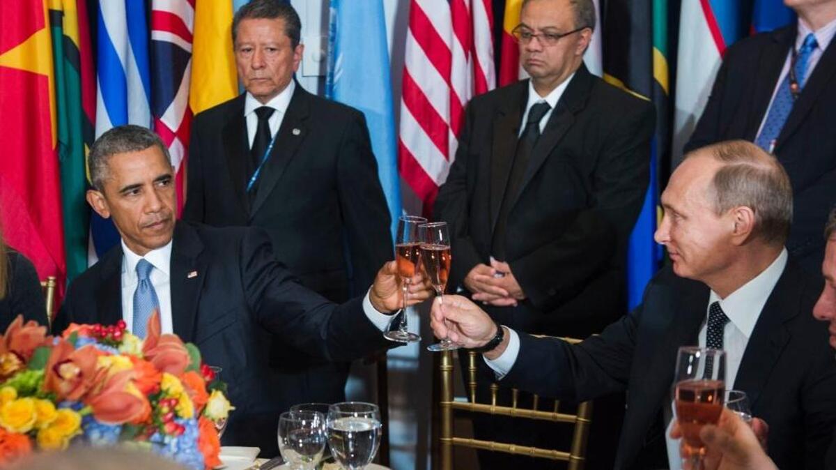 
President Barack Obama, left, and Russian President Vladimir Putin share an awkward toast during a luncheon at the United Nations on Monday.
