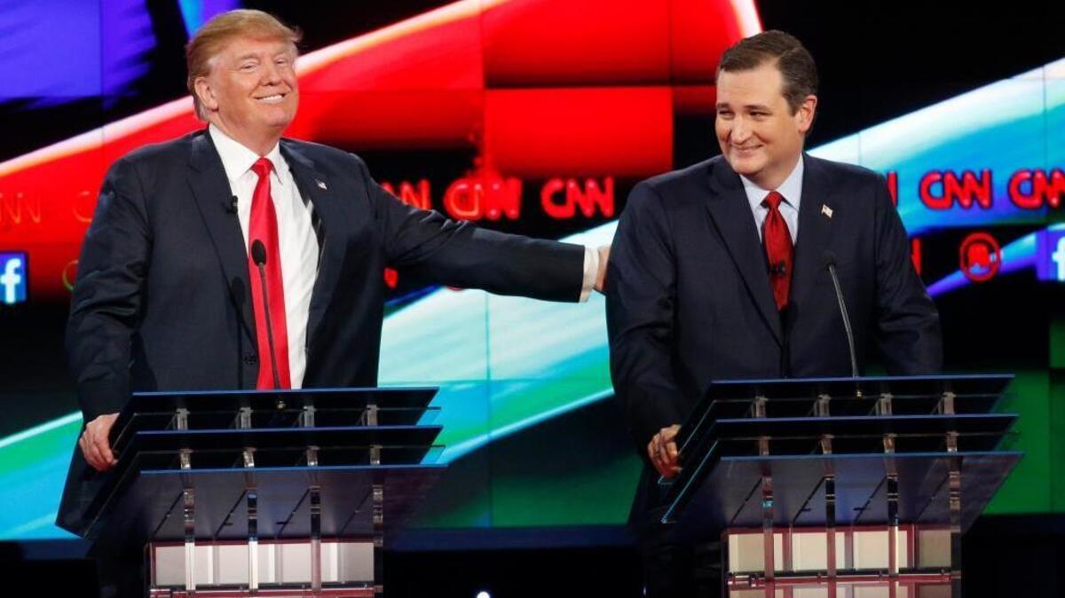 Donald Trump, left, joked with Ted Cruz during the Republican presidential on Dec. 15. But now that Cruz has passed him in the Iowa polls, Trump is raising “birther” doubts about Cruz.