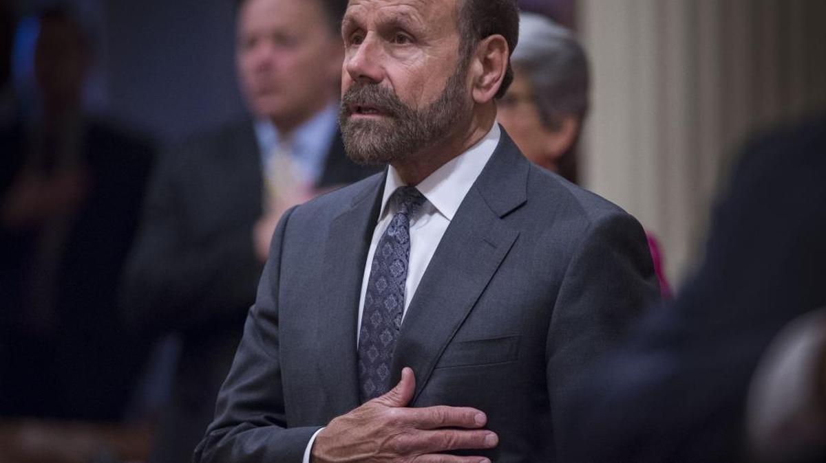 Sen. Jerry Hill, D-San Mateo, pledging allegiance during a Senate session, wants to toughen disclosure laws for problem doctors and nurses.