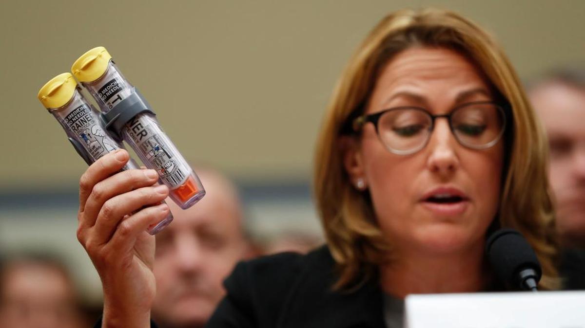 Mylan CEO Heather Bresch, holding up EpiPen devices, appeared on Capitol Hill in September 2016 before the House Oversight Committee for a hearing on EpiPen price increases.