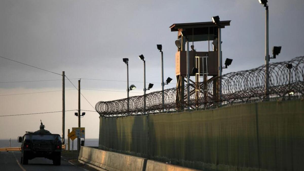 A guard looks out from a tower at the detention facility at Guantánamo Bay in Cuba in this March 2010 photo. The Senate on Tuesday overwhelmingly passed a defense bill barring any detainees from being transferred to the United States.