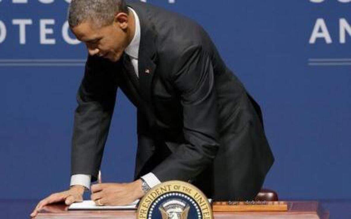 
President Barack Obama signs an executive order after speaking Friday at the White House Summit on Cybersecurity and Consumer Protection at Stanford University.
