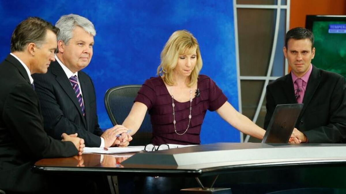 
WDBJ-TV7 news morning anchor Kimberly McBroom, second from right, and meteorologist Leo Hirsbrunner, right, are joined by visiting anchor Steve Grant, second from left, and Dr. Thomas Milam, of the Carilion Clinic, as they observe a moment of silence during the early morning newscast at the station, in Roanoke, Va. Colleagues Alison Parker and cameraman Adam Ward were gunned down Wednesday during a live broadcast.
