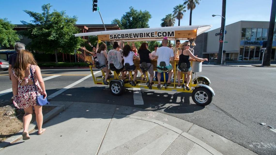 
Chelsea Irving, right seat, pedals with friends on the Sac Brew Bike to Kupros Craft House for beer. 
