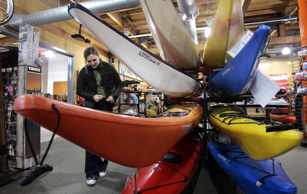 Rachel Hartman looks over sea kayaks as she shops for a birthday present for herself at REI Co-op. The retailer plans to open an Elk Grove location in 2025.