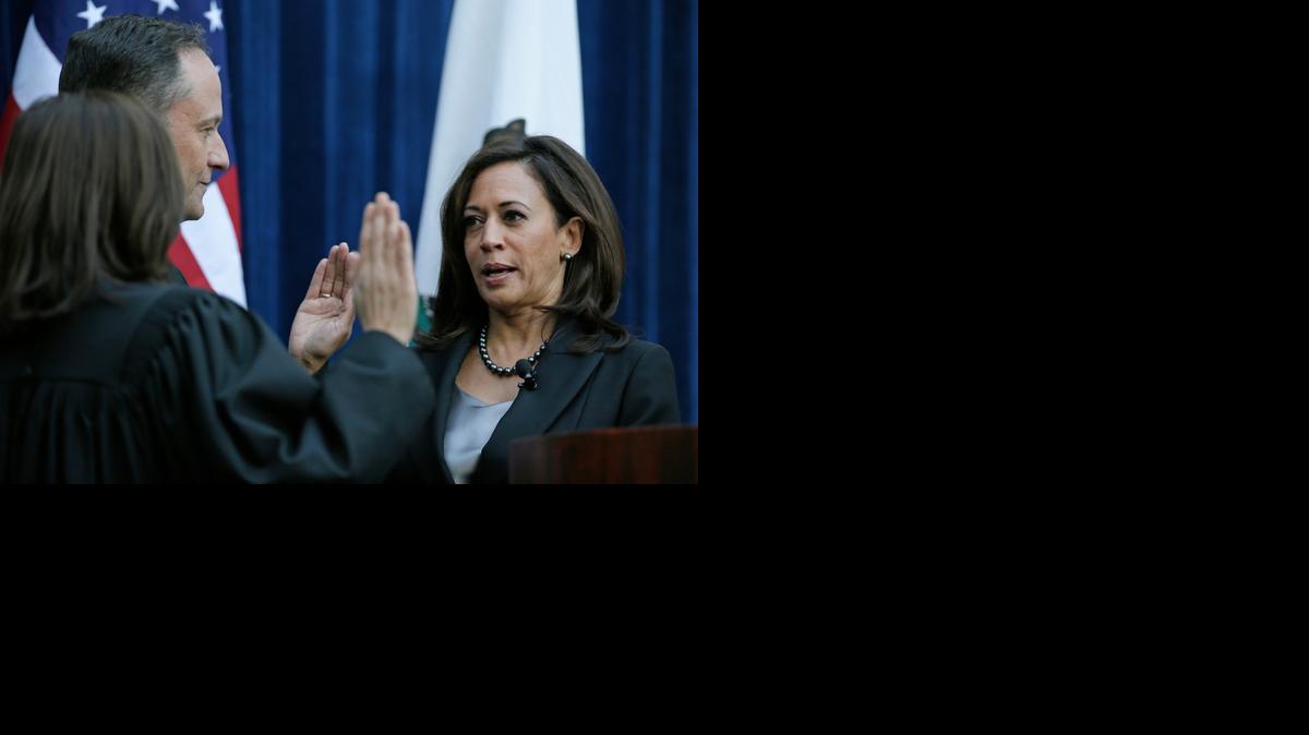 
California Attorney General Kamala Harris takes the oath of office from California Supreme Court Chief Justice Tani Cantil-Sakauye as her husband, Douglas Emhoff, looks on Monday at the Crocker Art Museum. Harris touted her fight against organized human trafficking after being sworn in to her second four-year term as California's top law enforcement official.  Harris is widely expected to be preparing for a run for governor or U.S. Senate. 
