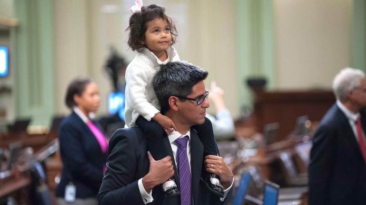 Two-year-old Ava Perea looks at the gallery as she is carried on her father Assemblyman Henry T. Perea, D-Fresno after he was sworn in during the first day of session at the State Capitol in Sacramento, Calif. on Monday, Dec. 3, 2012 .