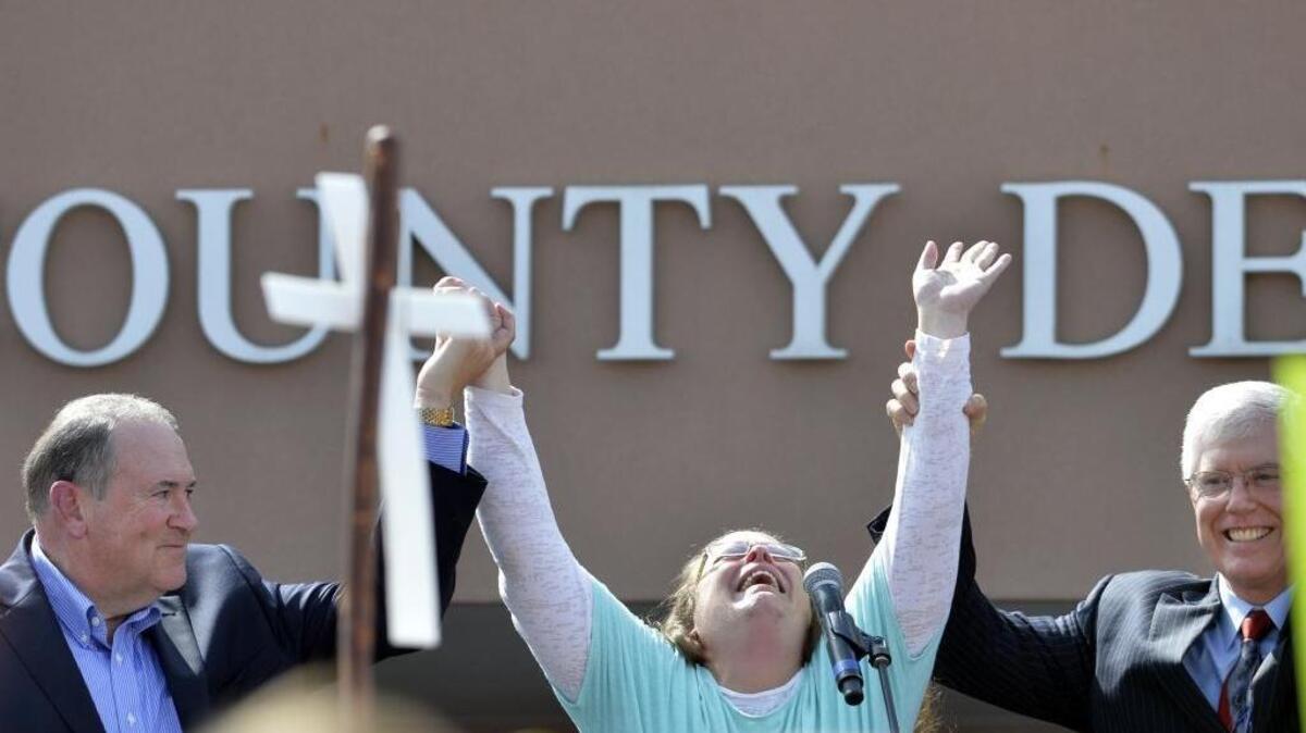 
Rowan County Clerk Kim Davis, center, with Republican presidential candidate Mike Huckabee, left, and attorney Mat Staver, founder of the Liberty Counsel, the Christian law firm representing Davis, at her side, cries out after being released from the Carter County Detention Center in Grayson, Ky., on Tuesday.
